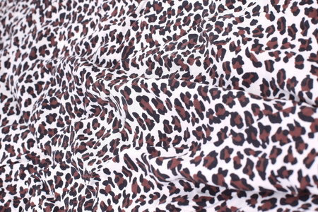 abstract background composed of leopard print fabric. the concept of creativity