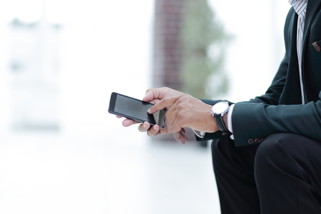 closeup. employee typing SMS on the smartphone.photo with copy spaceの写真素材
