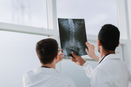 rear view.medical colleagues looking at the patient's x-ray. the concept of healthの写真素材
