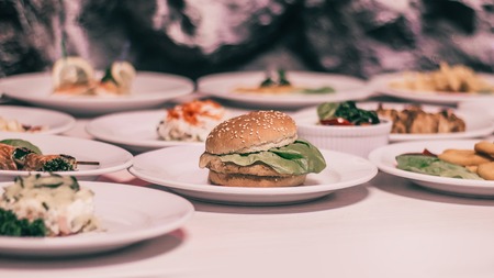 hamburger and many other snacks on the table in the restaurant .の写真素材