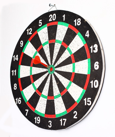 Close up shot red dart arrow on center of dartboard, metaphor to target successの写真素材