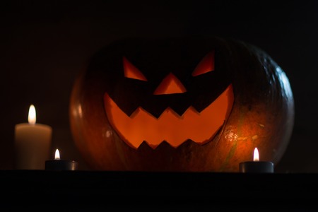 candles and pumpkin for Halloween on dark background.photo with copy spaceの写真素材
