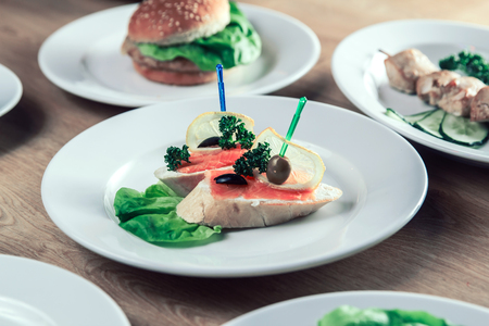 appetizer with salted salmon and other dishes on the table.の写真素材