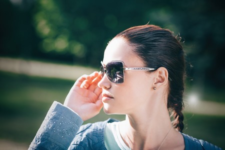 close up.beautiful young woman looking through sunglassesの写真素材