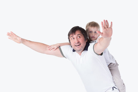 cheerful father playing with his young son.isolated on whiteの写真素材