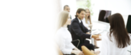 Handshake trading partners, sitting behind a Desk in the blurの写真素材