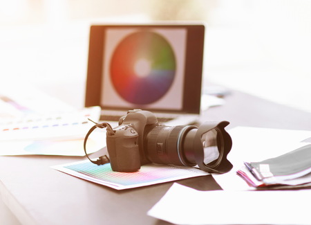 Camera, fabric samples and sketches are on the desktop