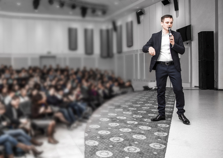 Speaker speaks at a business conference in front of entrepreneurs and journalistsの写真素材