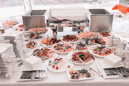 Variety of snacks and dishes on the table in the restaurantの写真素材