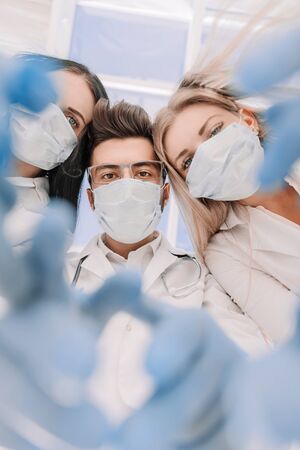 Team surgeons are performing an operation using medical instruments, in a modern operating room,の写真素材