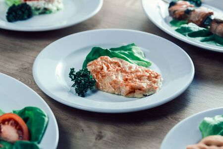 chicken fillet in cheese, and lettuce on the dining tableの写真素材