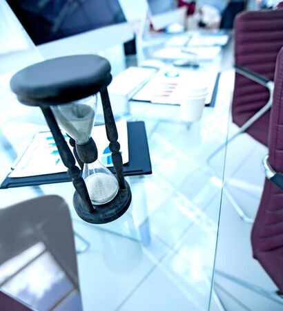 closeup.the hourglass on the Desk of a businessman.