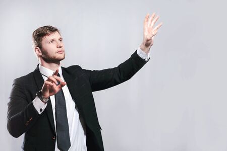 young businessman stretching his hands to virtual poster