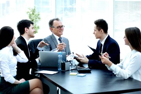 Manager and business group discussing financial documentsの写真素材