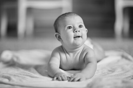 cute baby lying on blanket and looking up