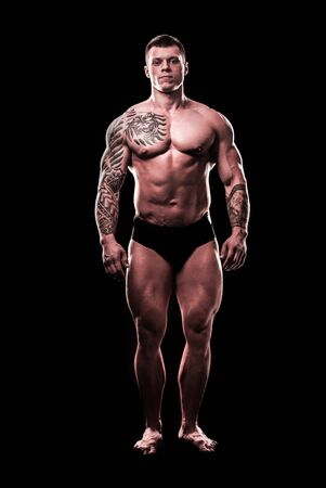 in full growth. beautiful strong man bodybuilderの写真素材