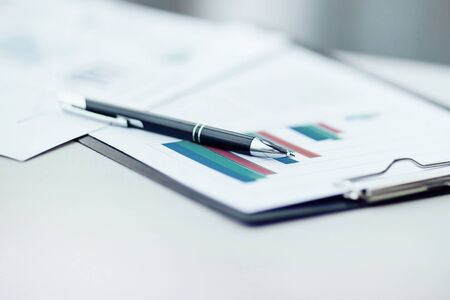 pen and financial report on office Desk backgroundの写真素材