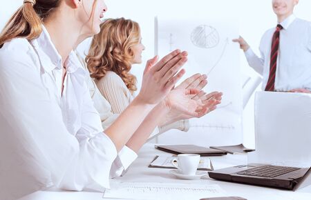 closeup.business team applauding the speaker at a business conferenceの写真素材