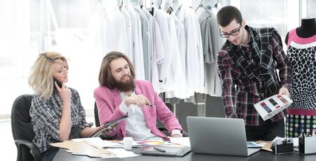 two fashion designers are working on creating womens clothing in the Studioの写真素材