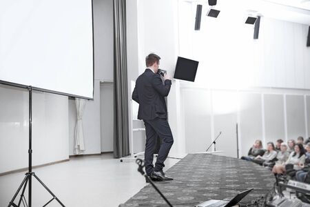 audience listens to the speaker in the conference roomの写真素材
