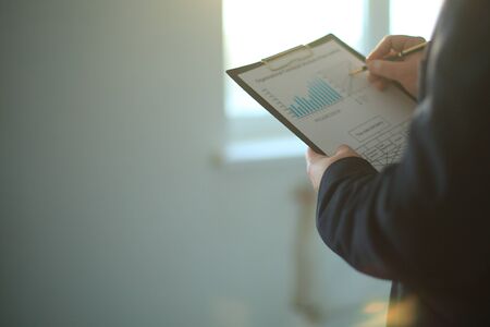 close up of businessman checks the financial schedule.