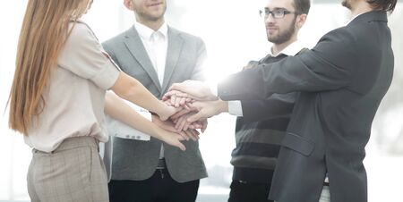 businessman and his business team with hands clasped together to show their unityの写真素材
