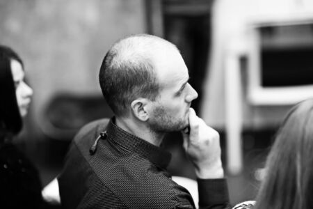 attentive businessman listens to the report of the speakerの写真素材