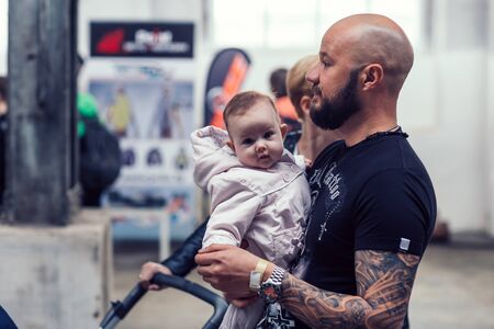 Belarus, Minsk, may 17, 2015, Oktyabrskaya street, biker festival. man biker with his little son standing on a city streetのeditorial素材