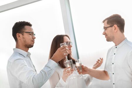 close up.business team holding a glass of wine.の写真素材