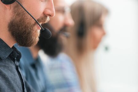 close up. professional call center employee in the workplace.