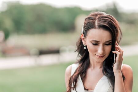 close up. upset bride talking on a mobile phone.の写真素材