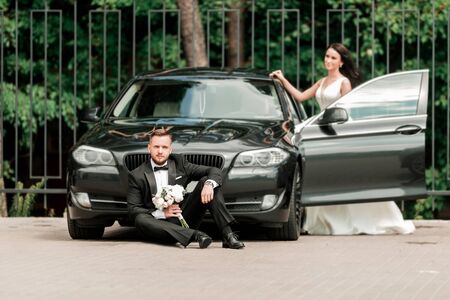 photo newlyweds on a walk near their cars.の写真素材