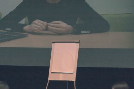 image of a businessman on the screen in the hall of the business club.