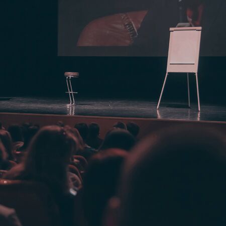 screen, high chair and flipchart on the podium in the conference room