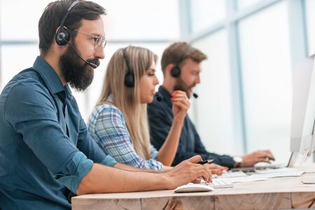 close up. call center operators work in a modern office.の写真素材