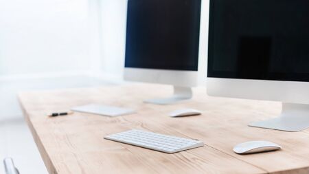 background image of personal computers on the office Deskの写真素材