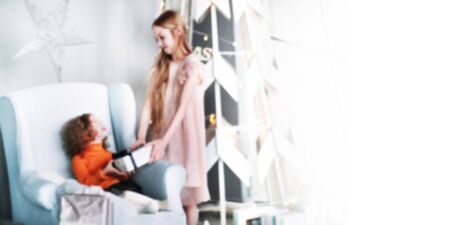 two happy little sisters with Christmas presents. blurred image for the advertising text. photo with copy spaceの写真素材