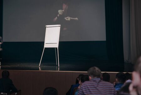 flipchart and big screen on stage in the conference room.の写真素材