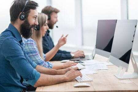 call center employees work on PC in the officeの写真素材