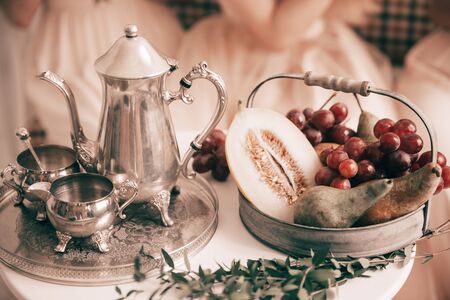 coffee set and fruit bowl on the table at the newlywedsの写真素材