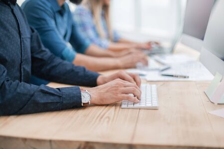 close up. group employees using computers to analyze incoming information