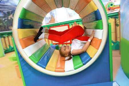 happy little girl playing on an inflatable Playgroundの写真素材
