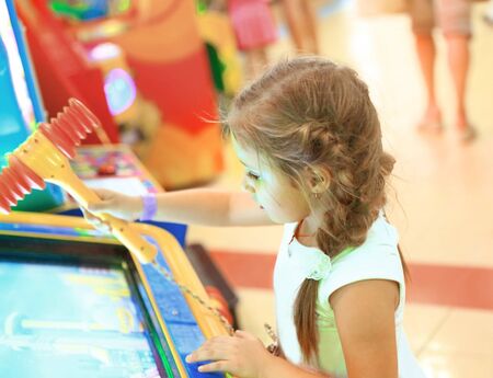 little girl near the slot machine in the entertainment center