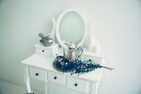 olive branch and silver service in a stylish boudoir.
