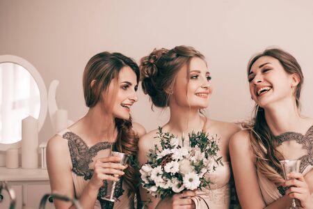 portrait of happy cute girl bride with her friendsの写真素材