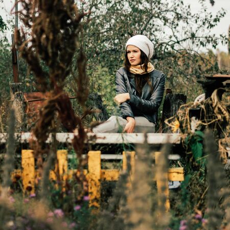 girl resting near the house on a warm autumn day.の写真素材