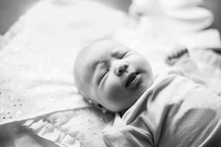 photo in retro style. newborn baby lying on the changing tableの写真素材