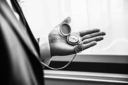 black and white photo with noise. young businessman looking at his watch. business concept