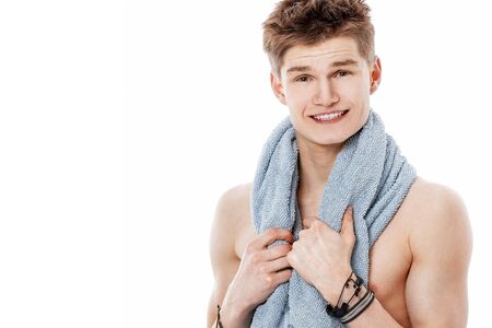 young man with towel relaxing after shower.の写真素材