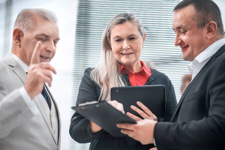 project Manager discussing working documents with colleaguesの写真素材